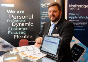 Mike Lomas at conference stand